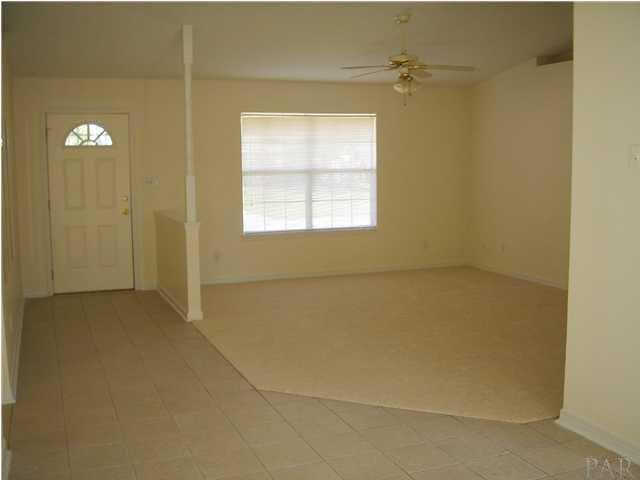 2797 Augustus Road Navarre, FL 32566 - Photo 6 of 7 View of living room area with cathedral ceilings and new carpeting; Tiled foyer