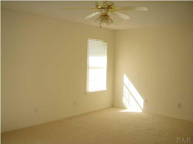 2797 Augustus Road Navarre, FL 32566 - Photo 7 of 7 Spacious master bedroom with trey ceilings and new carpeting