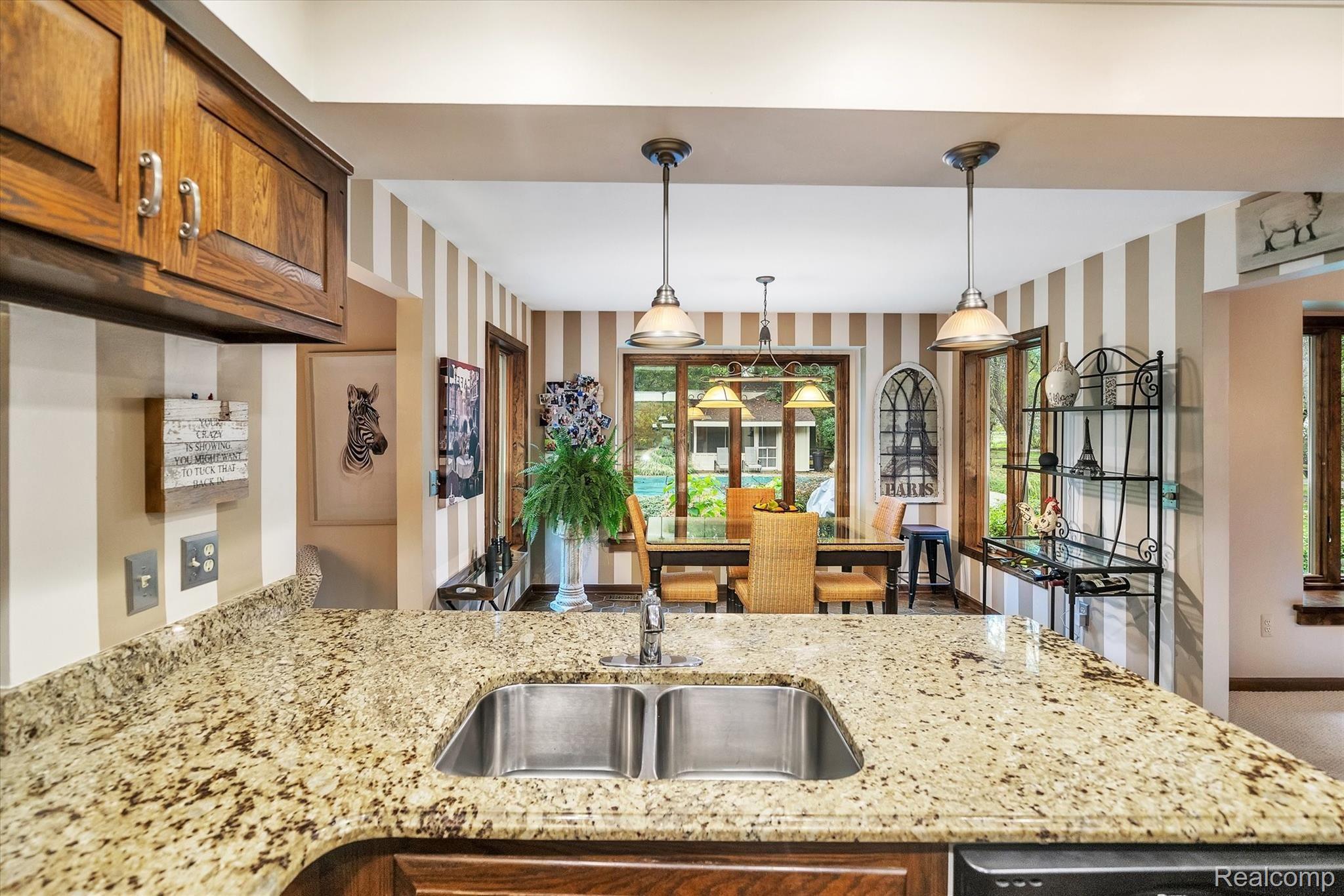 3073 Gentry Road Howell, MI 48843 - Photo 12 of 57 Cook's kitchen with granite counters, new fridge, and tons of storage
