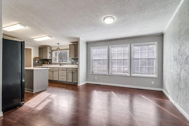 a view of kitchen with wooden floor and electronic appliances