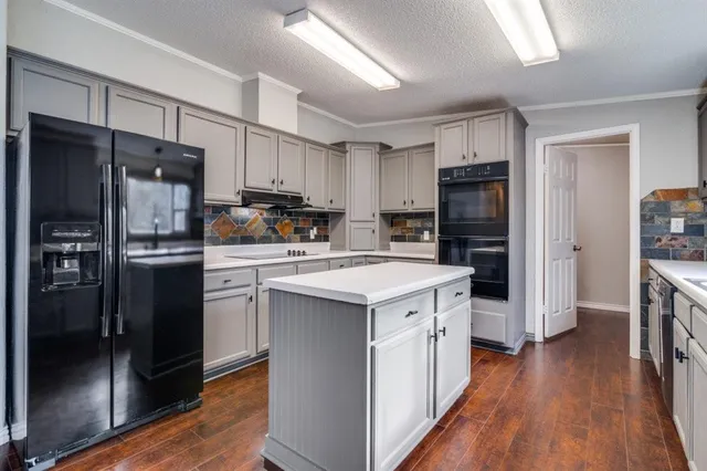a kitchen with stainless steel appliances a refrigerator stove microwave and sink