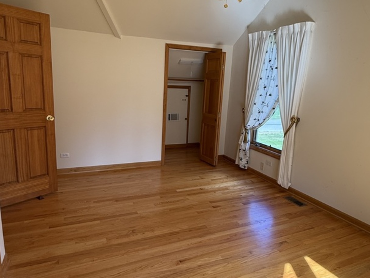 125 Maple Court, Unit 1 Geneva, IL 60134 - Photo 12 of 18 an empty room with wooden floor and entrance