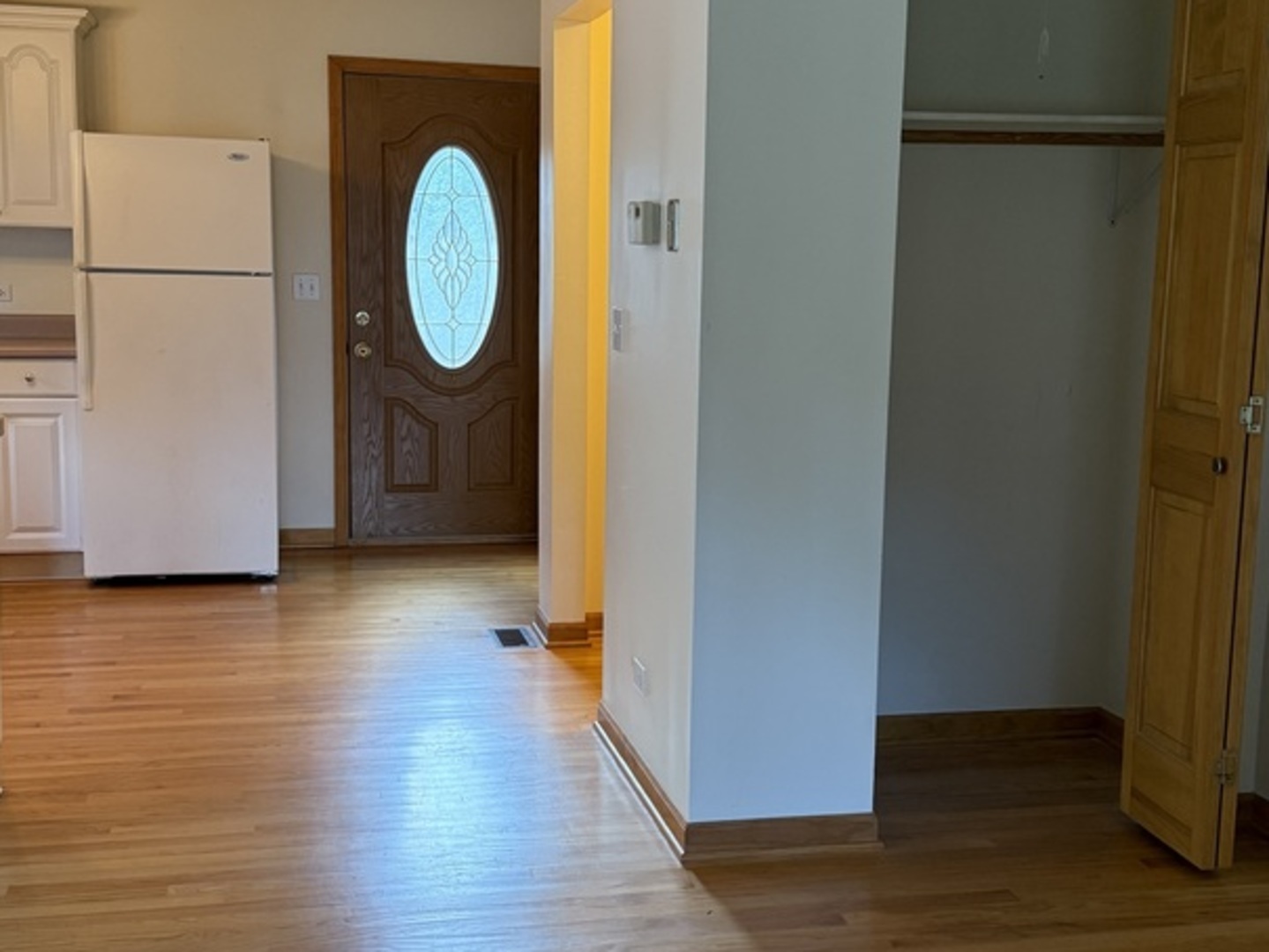 125 Maple Court, Unit 1 Geneva, IL 60134 - Photo 2 of 18 a view of a room with wooden floor and a white door