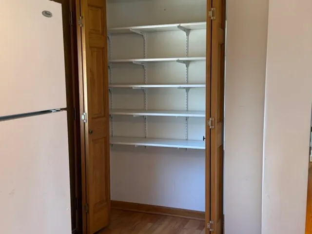 a view of a walk in closet with empty racks