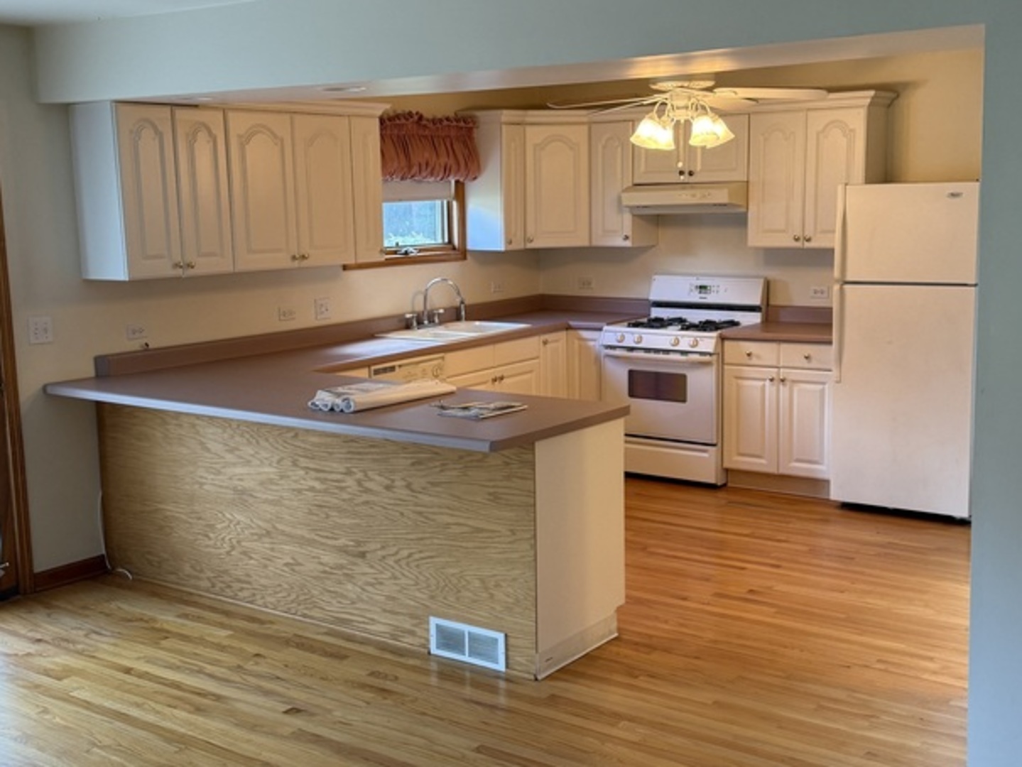 125 Maple Court, Unit 1 Geneva, IL 60134 - Photo 5 of 18 a kitchen with stainless steel appliances granite countertop a stove a sink and a refrigerator