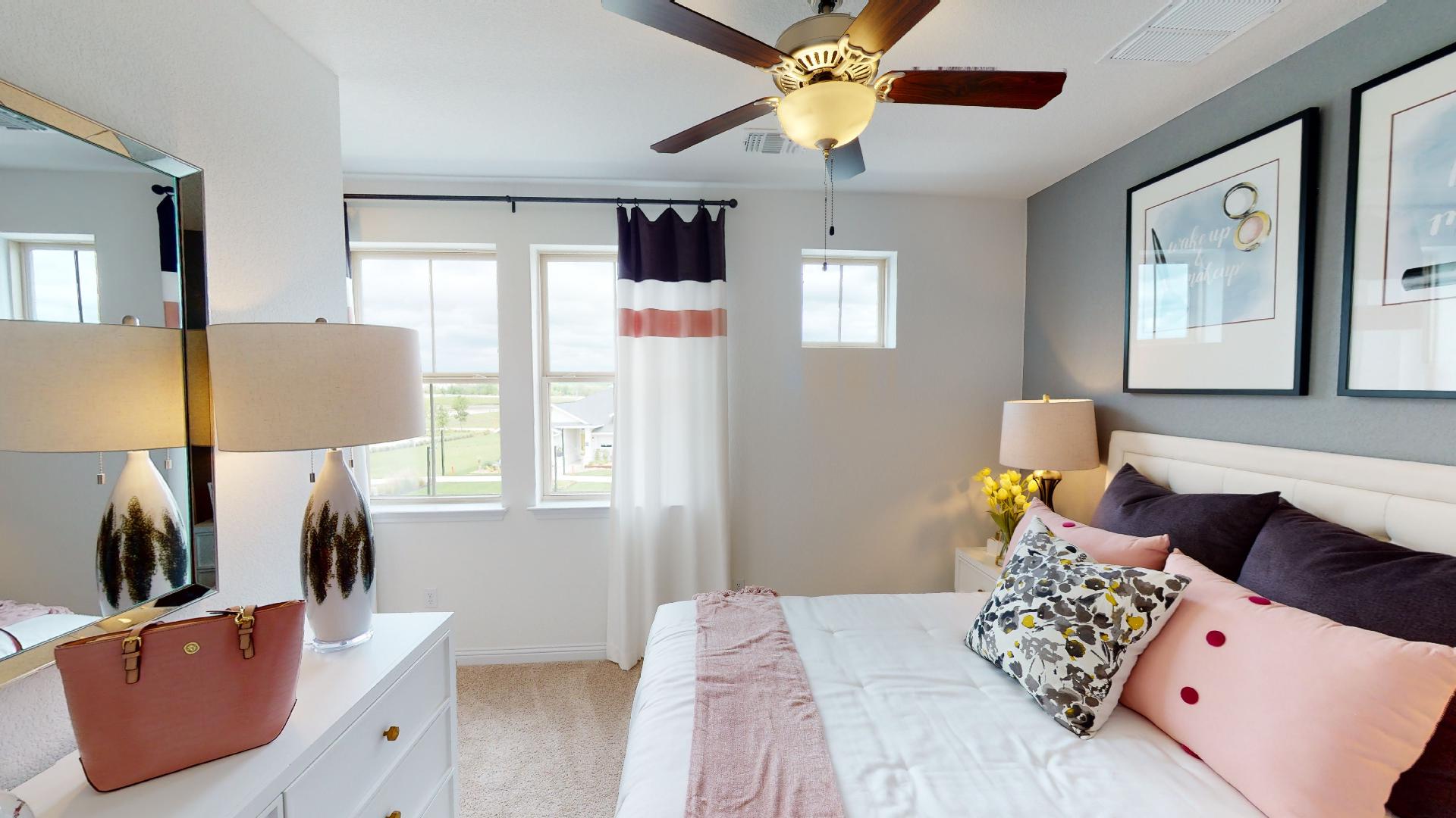 8113 Springsteen Drive Austin, TX 78744 - Photo 8 of 10 Bedroom featuring light carpet and a ceiling fan