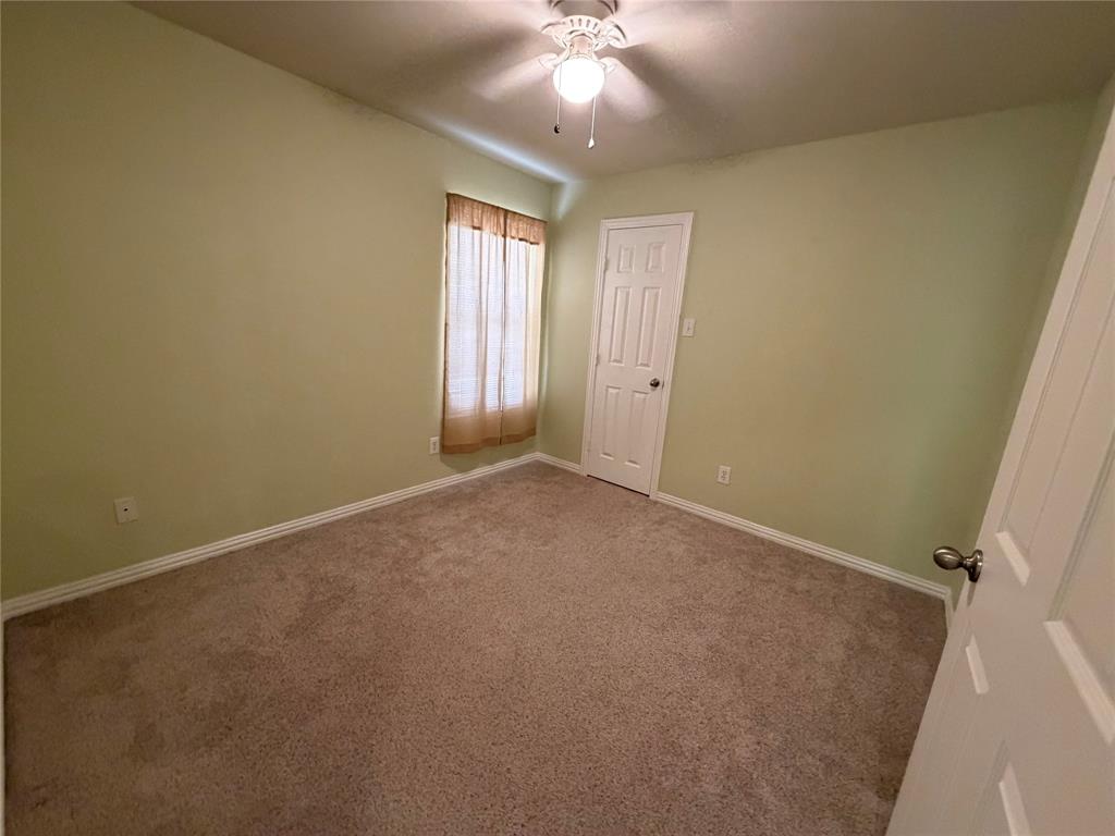 4618 Island Bay Drive Arlington, TX 76119 - Photo 11 of 16 an empty room with windows and fan