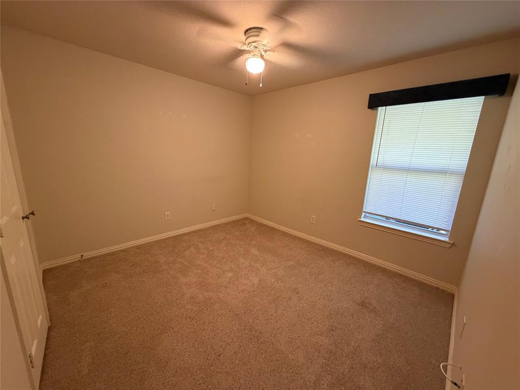 4618 Island Bay Drive Arlington, TX 76119 - Photo 13 of 16 an empty room with a window and a ceiling fan