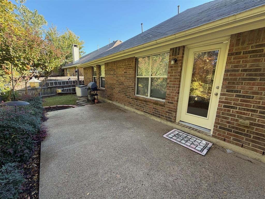 4618 Island Bay Drive Arlington, TX 76119 - Photo 15 of 16 a view of a house with a barbeque and large trees
