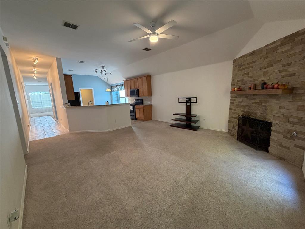 4618 Island Bay Drive Arlington, TX 76119 - Photo 5 of 16 a living room with furniture and a fireplace