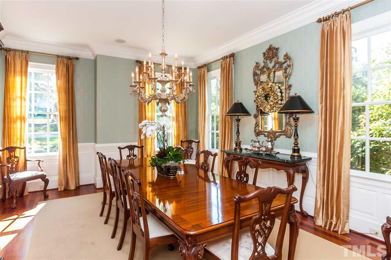 1807 Chester Road Raleigh, NC 27608 - Photo 4 of 25 a dining room with furniture a chandelier and a rug