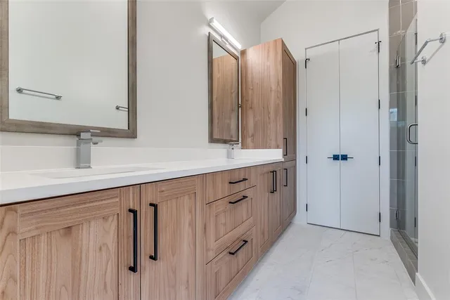 a bathroom with double vanity sink and a mirror