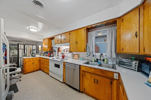 a kitchen with a sink stove and cabinets