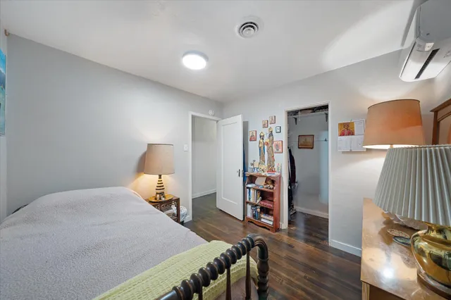 a bedroom with furniture and a wooden floor