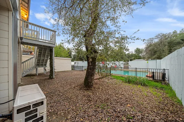 a view of a street with brick wall and potted plants