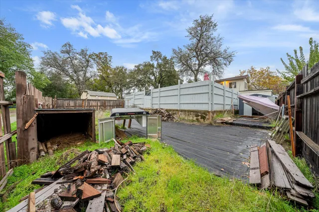 a view of a backyard with sitting area
