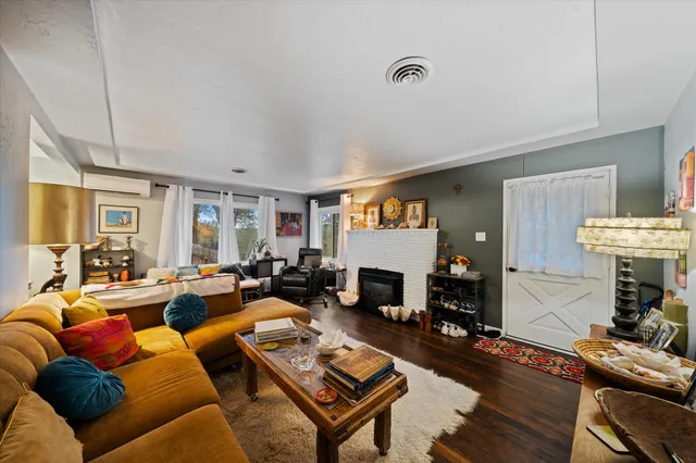a living room with furniture a fireplace and a table
