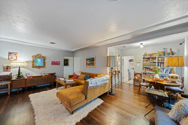 a bedroom with furniture and a wooden floor