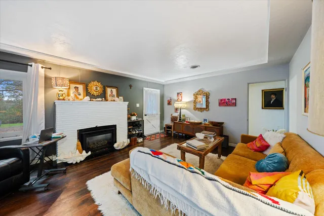 a living room with furniture fireplace and flat screen tv