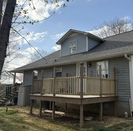 a view of a house with a wooden deck