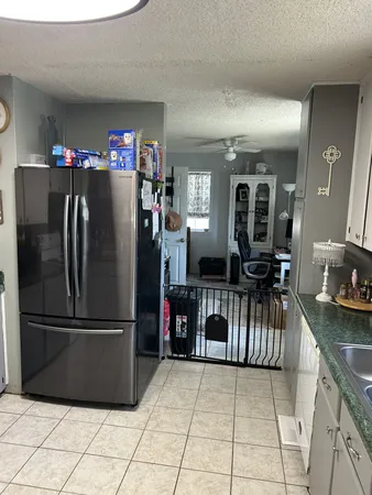 a kitchen with granite countertop a sink a stove and cabinets