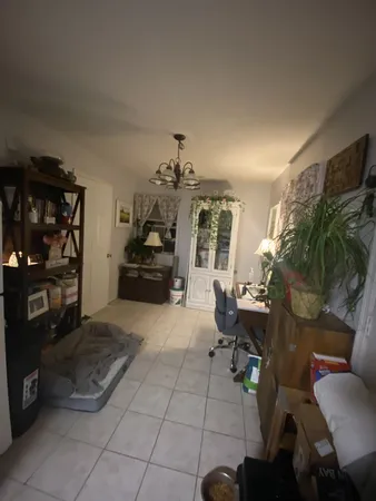 a large bed sitting in a room next to a window