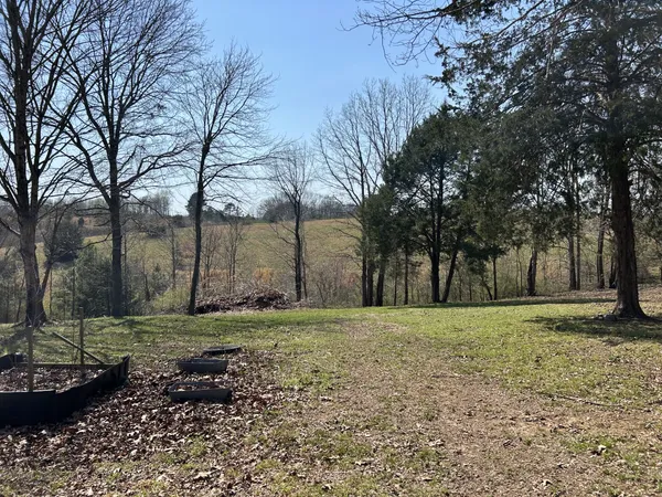 a big house with trees in the background