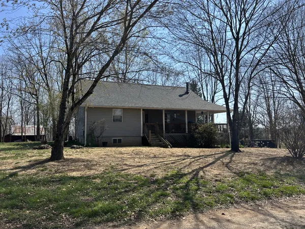 a front view of a house with a yard covered in snow