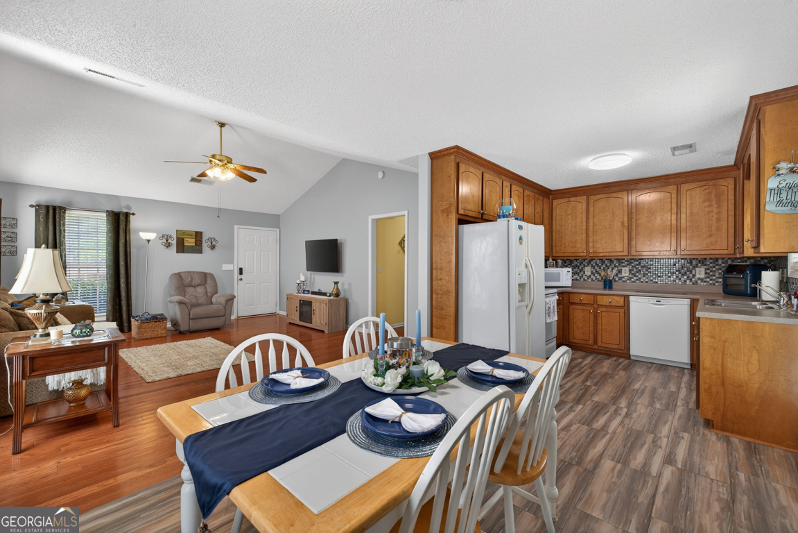 141 Pope Street Zebulon, GA 30295 - Photo 11 of 42 a living room with kitchen island furniture and a kitchen view