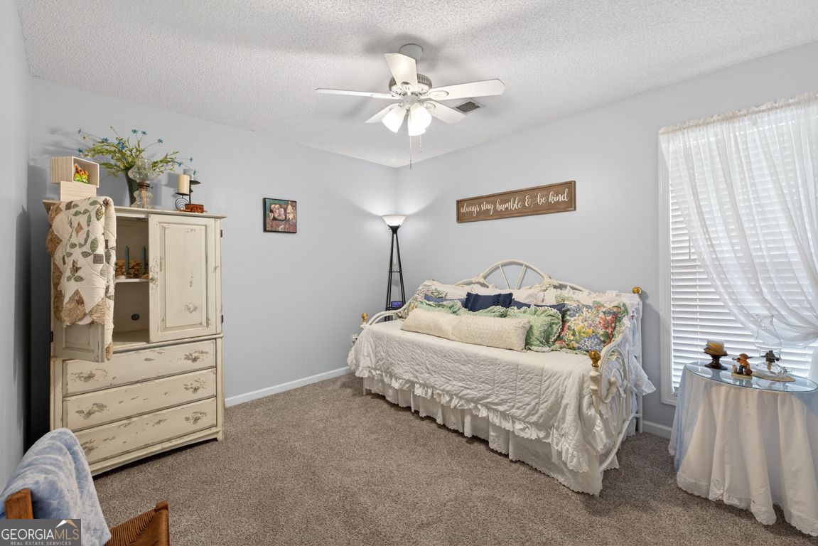 141 Pope Street Zebulon, GA 30295 - Photo 16 of 42 a bedroom with a bed and furniture