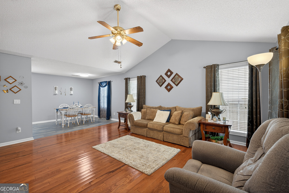 141 Pope Street Zebulon, GA 30295 - Photo 2 of 42 a living room with furniture and a chandelier