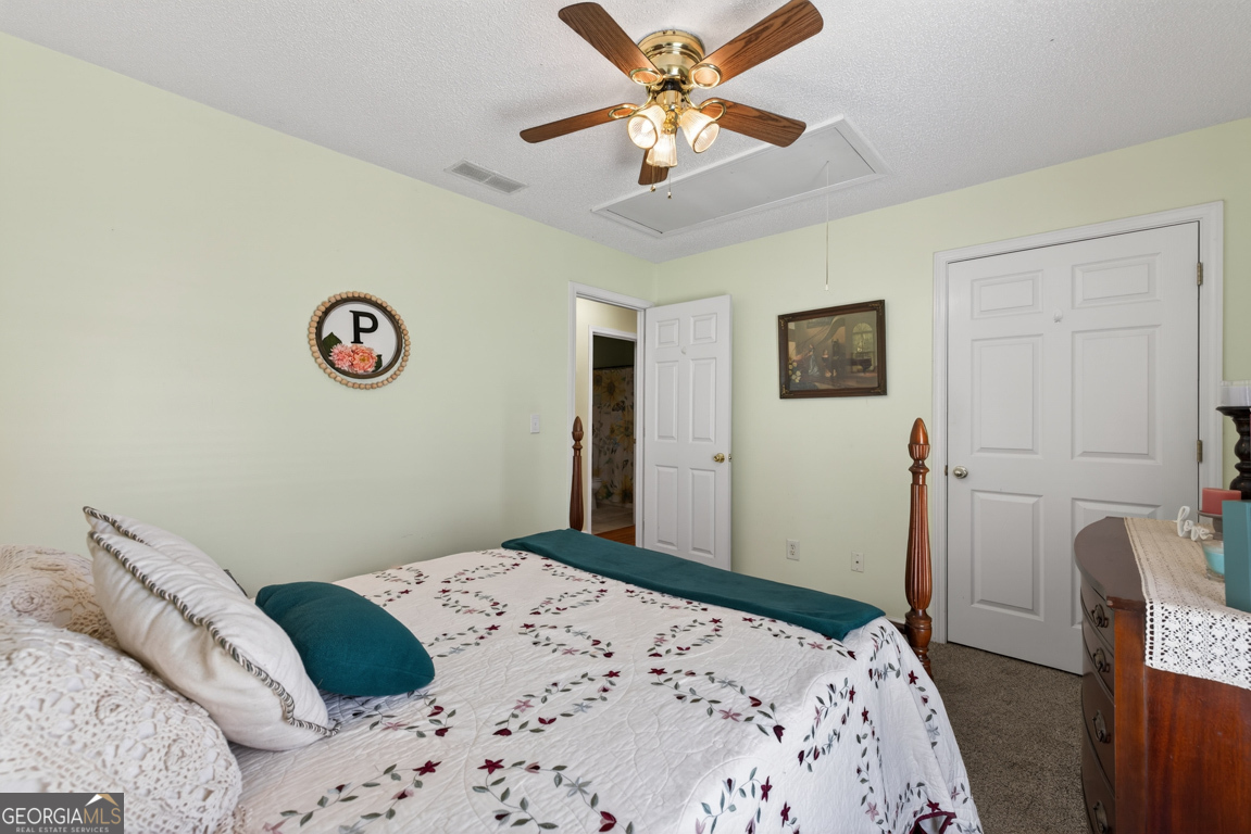 141 Pope Street Zebulon, GA 30295 - Photo 21 of 42 a bedroom with a bed and a chandelier