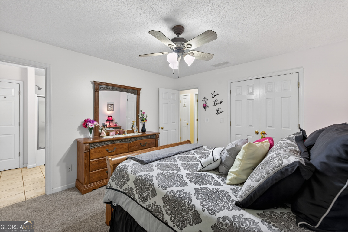 141 Pope Street Zebulon, GA 30295 - Photo 22 of 42 a bedroom with a bed and a chandelier