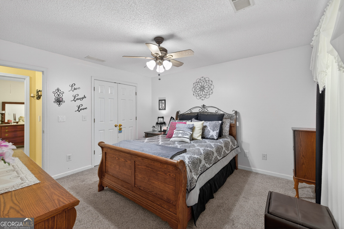 141 Pope Street Zebulon, GA 30295 - Photo 23 of 42 a bed room with a bed and a chandelier