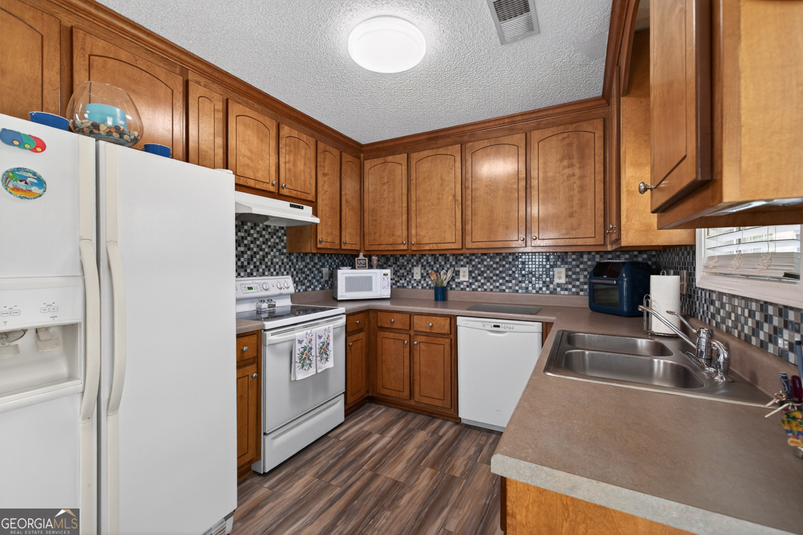 141 Pope Street Zebulon, GA 30295 - Photo 5 of 42 a kitchen with stainless steel appliances granite countertop a sink stove and refrigerator