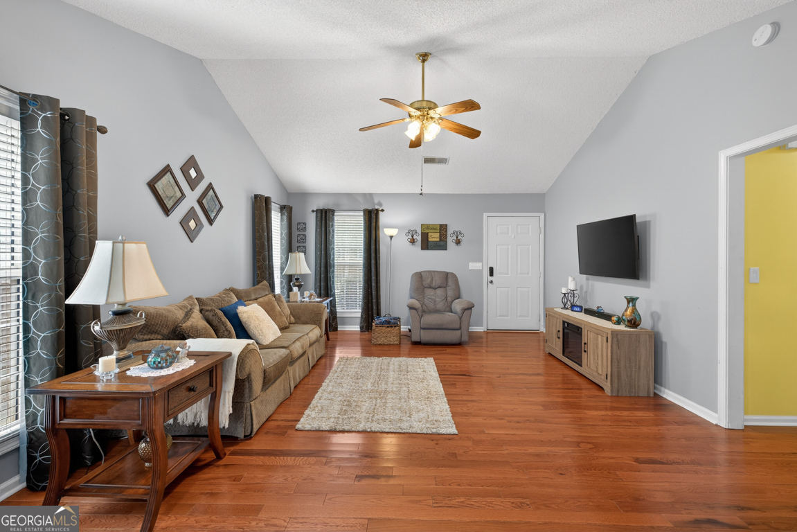 141 Pope Street Zebulon, GA 30295 - Photo 7 of 42 a living room with furniture and a flat screen tv