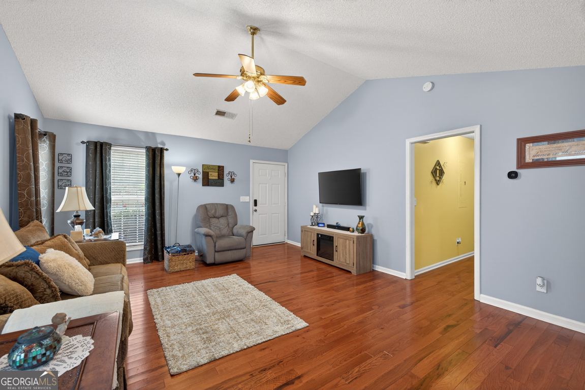 141 Pope Street Zebulon, GA 30295 - Photo 8 of 42 a living room with furniture and a flat screen tv