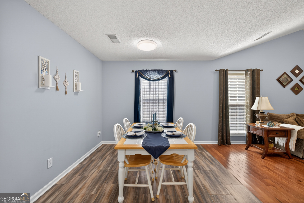 141 Pope Street Zebulon, GA 30295 - Photo 9 of 42 a dining room with furniture and wooden floor