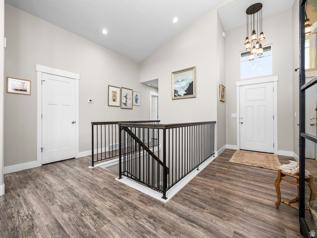 7 Sterling Loop Vineyard, UT 84059 - Photo 29 of 43 Entryway featuring wood-finish flooring, a contemporary chandelier, and a two-story vaulted ceiling