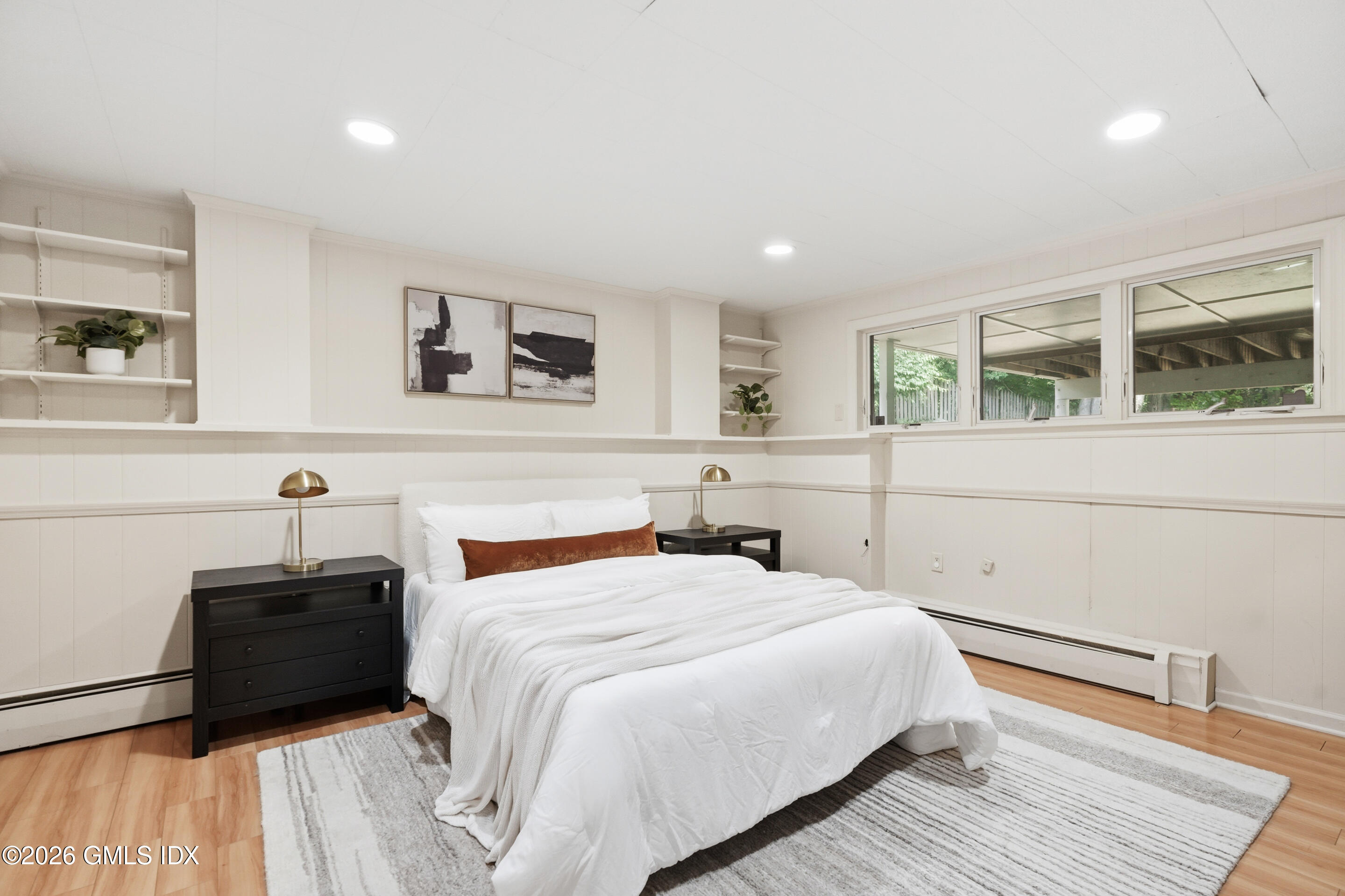 33 Sachem Road Greenwich, CT 06830 - Photo 17 of 35 a bedroom with a bed and a large window