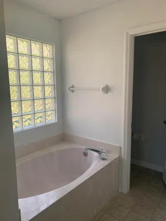 a white bath tub sitting next to a window