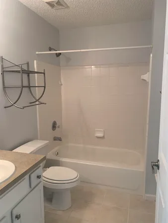 a bathroom with a toilet a sink and shower