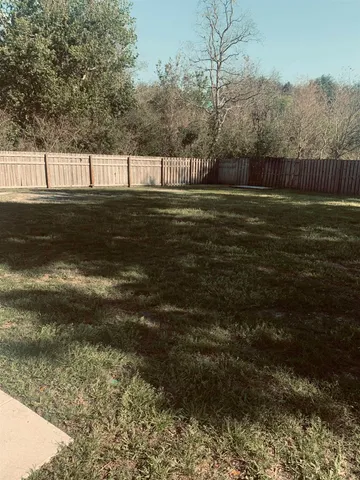 a view of swimming pool with a yard