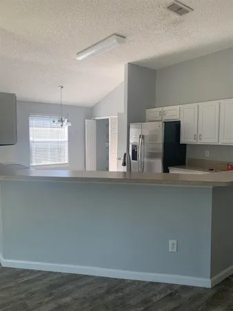 a kitchen with stainless steel appliances a sink and a microwave
