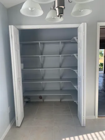 a view of storage and utility room with empty racks