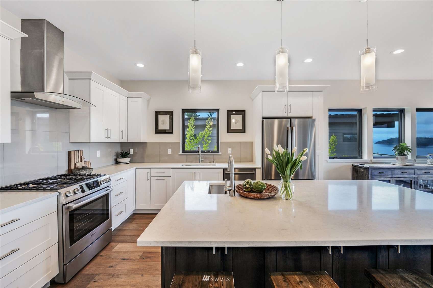 4920 Heather Drive Anacortes, WA 98221 - Photo 15 of 40 a kitchen with kitchen island granite countertop a stove a sink a refrigerator and wooden cabinets