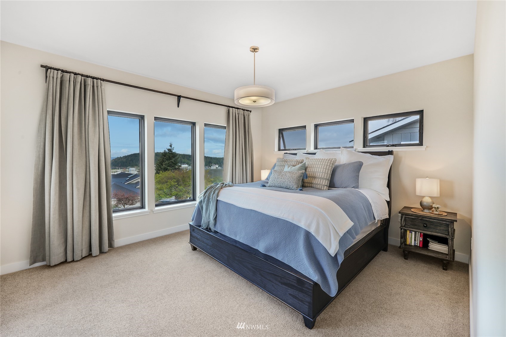 4920 Heather Drive Anacortes, WA 98221 - Photo 16 of 40 a spacious bedroom with a bed and a large window