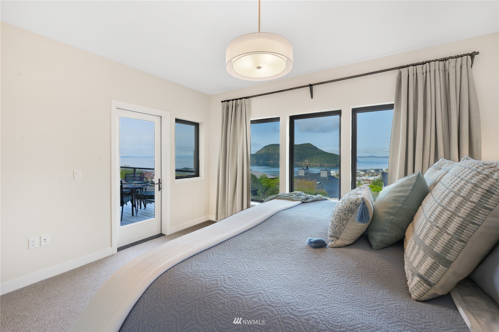 4920 Heather Drive Anacortes, WA 98221 - Photo 17 of 40 a bed sitting in a spacious bedroom next to a window