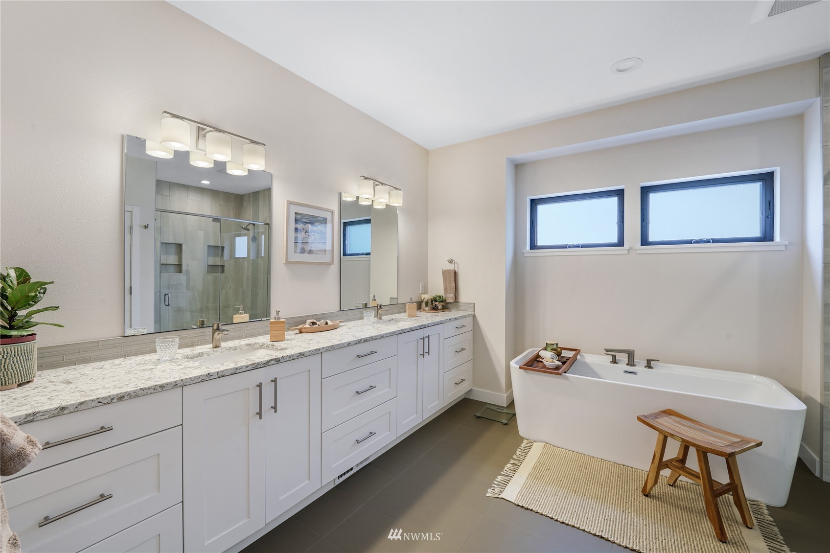 4920 Heather Drive Anacortes, WA 98221 - Photo 21 of 40 a spacious bathroom with a granite countertop sink and a mirror