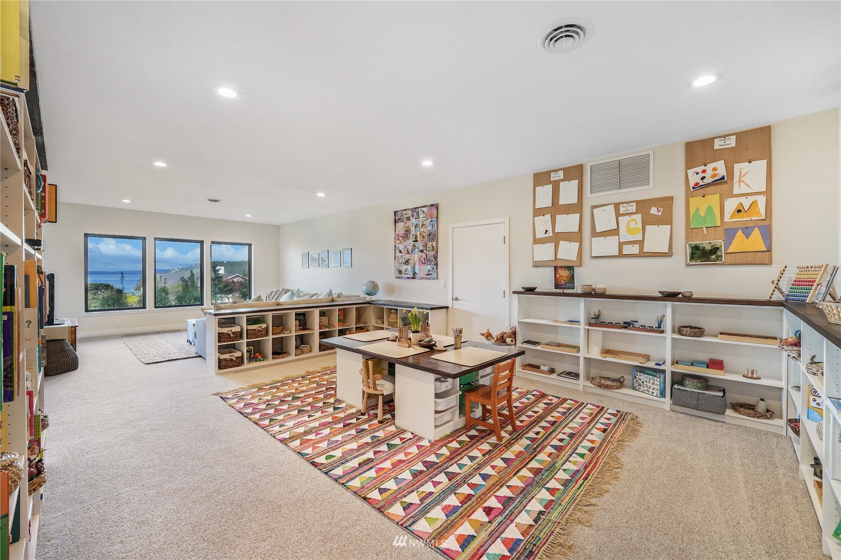 4920 Heather Drive Anacortes, WA 98221 - Photo 25 of 40 a living room with furniture a table and kitchen view